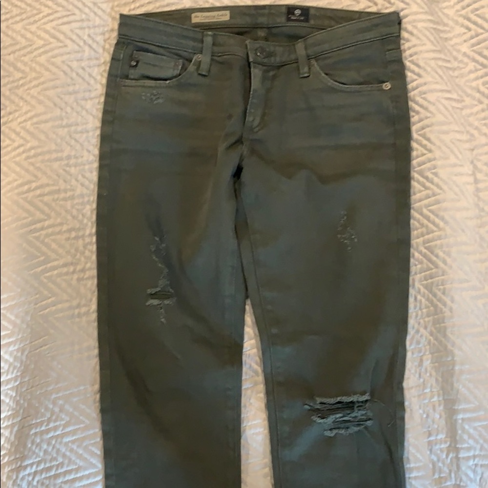 Distressed army green skinny jeans.